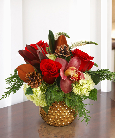 The Holiday Wishes Bouquet features hydrangea, roses, & orchids in a keepsake copper container.