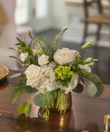The Let it Snow Petite Arrangement featuring hydrangea, orchids and roses.