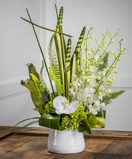 Ansley Park luxury flower arrangement features exotic white orchids in lush tropical foliage.