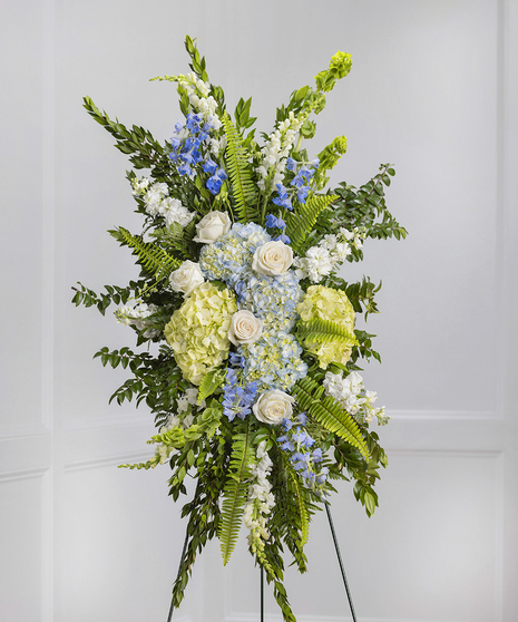 Blue & White Garden Sympathy Spray of hydrangea, snapdragons, delphinium on a standing easel