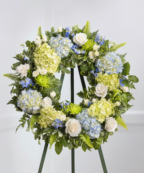 Blue and White Garden Floral Wreath on a standing easel featuring hydrangea, roses, delphinium and lush foliage