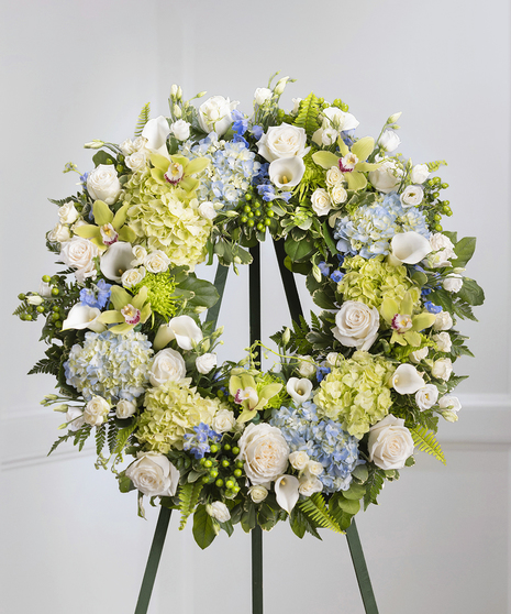 Blue and White Garden Floral Wreath on a standing easel featuring hydrangea, roses, delphinium and lush foliage
