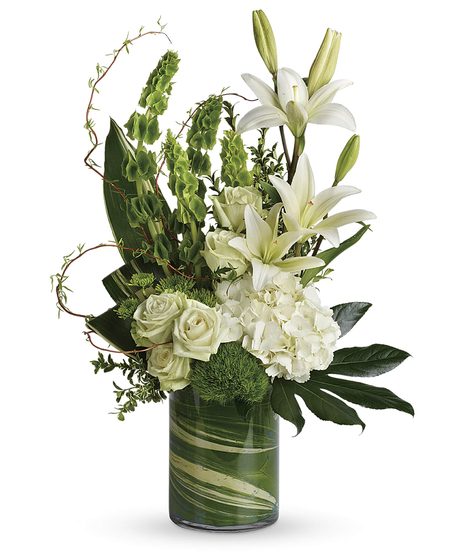 The Botanical Beauty Bouquet feauturing white lilies, white hydrangea, bells of Ireland in a leaf wrapped vase