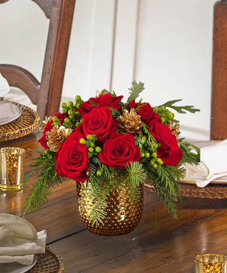 The Christmas Delight Bouquet features red roses, glass ornaments, and snow tipped cones in scented christmas greens.