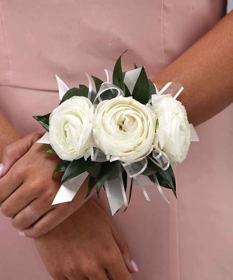 White ranunculus wrist corsage by Carithers Flowers Atlanta.