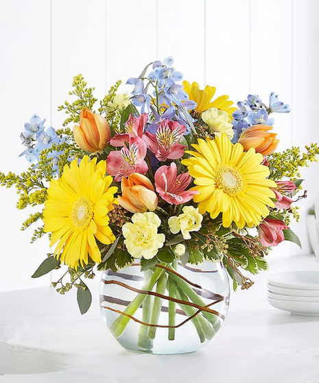 The Cottage Blossoms Bouquet features spring garden flowers in a chic vase
