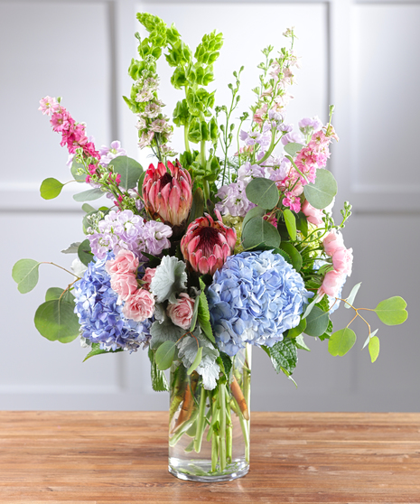 Pastel Garden Vista Bouquet features hydrangea, protea, roses, snapdragons and seasonal favorites.