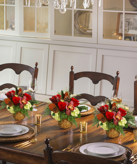 The Holiday Wishes Bouquet features hydrangea, roses, & orchids in a keepsake copper container.