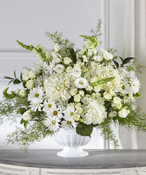 Love & Compassion Garden Pedestal Sympathy Arrangement featuring white hydrangea, white roses and snapdragons.