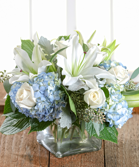 Blue and White Garden Centerpiece featuring hydrangea and roses by  Carithers Flowers Atlanta