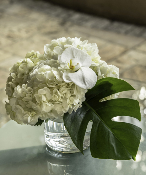 Mayfair Table Centerpiece in pedestal container featuring white seasonal flowers