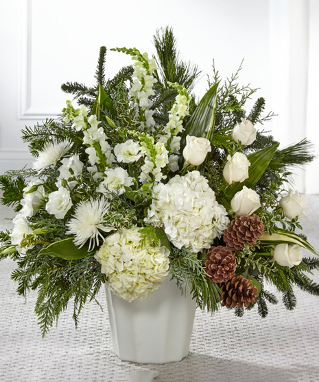 Winter Passage Garden Sympathy Basket featuring winter foliage, hydrangea, snapdragons and roses.