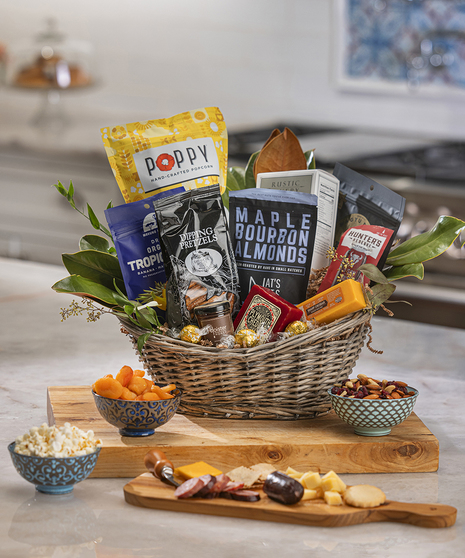 The Savory Gift Basket featuring crackers, cheese, sausage, nuts, popcorn, pretzels, and more.
