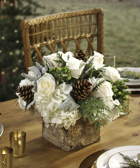 The Snowdrift Bouquet features invory roses in a cloud of white hydrangea and winter foliage.