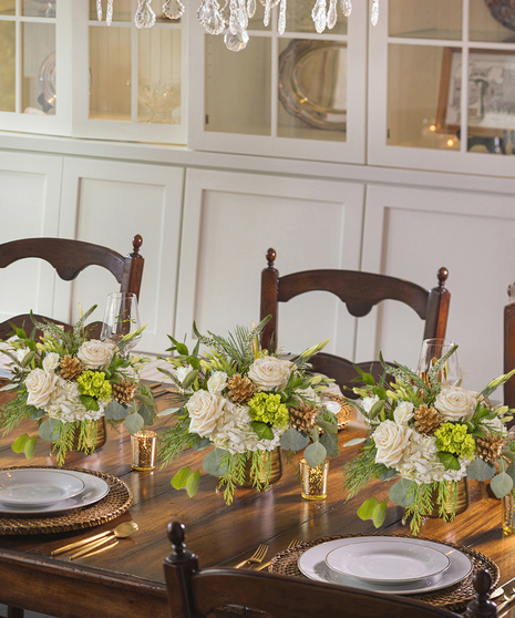 The Let it Snow Petite Arrangement featuring hydrangea, orchids and roses.