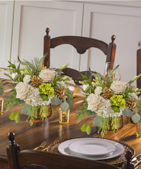 The Let it Snow Petite Arrangement featuring hydrangea, orchids and roses.