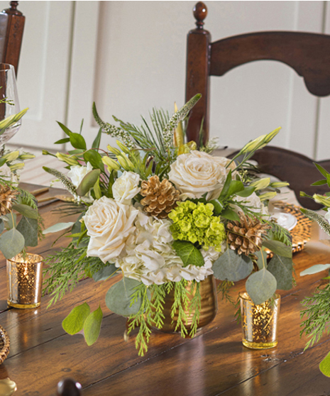 The Let it Snow Petite Arrangement featuring hydrangea, orchids and roses.